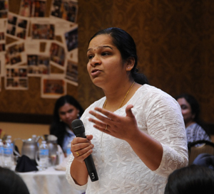 A Black woman speaks into a microphone