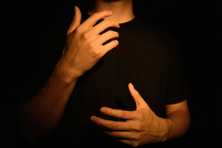 A pair of illuminated hands gesturing expressively